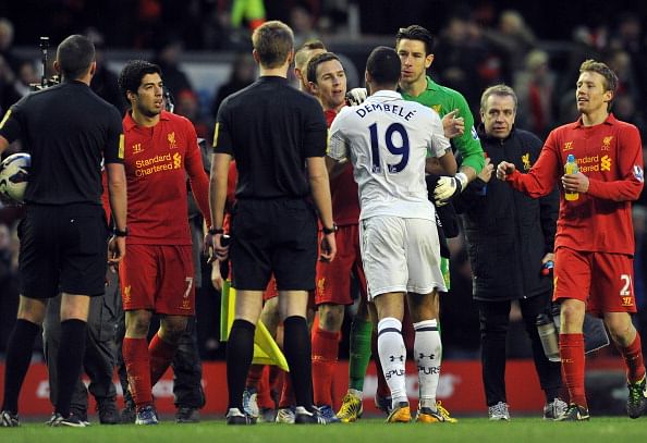 ottenham Hotspur's Belgian midfielder Mousa Dembele argues with Liverpool palyers after after the English Premier League football match between Liverpool and Tottenham Hotspur at Anfield stadium in Liverpool, northwest England, on March 10, 2013. AFP PHOTO